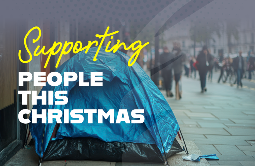 Homeless tent on street with 'Supporting People this Christmas'